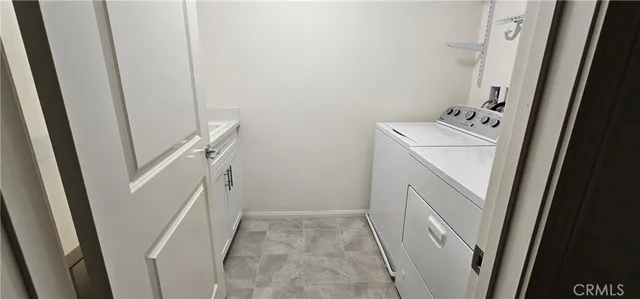 a utility room with a sink a washer and dryer
