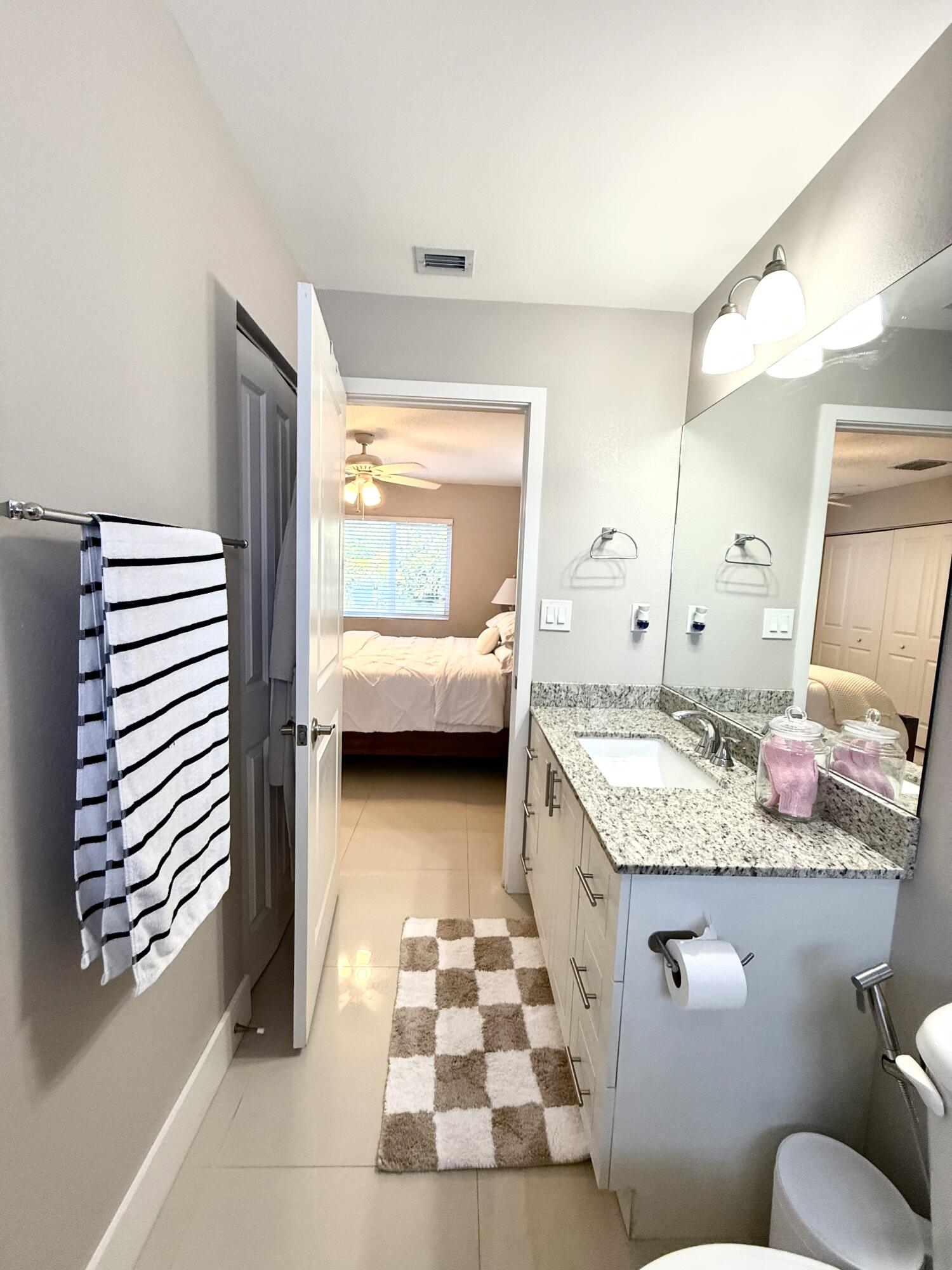 15 Lake View Drive Key Largo, FL 33037 - Photo 35 of 53 a en suite bathroom with a granite countertop sink and a mirror