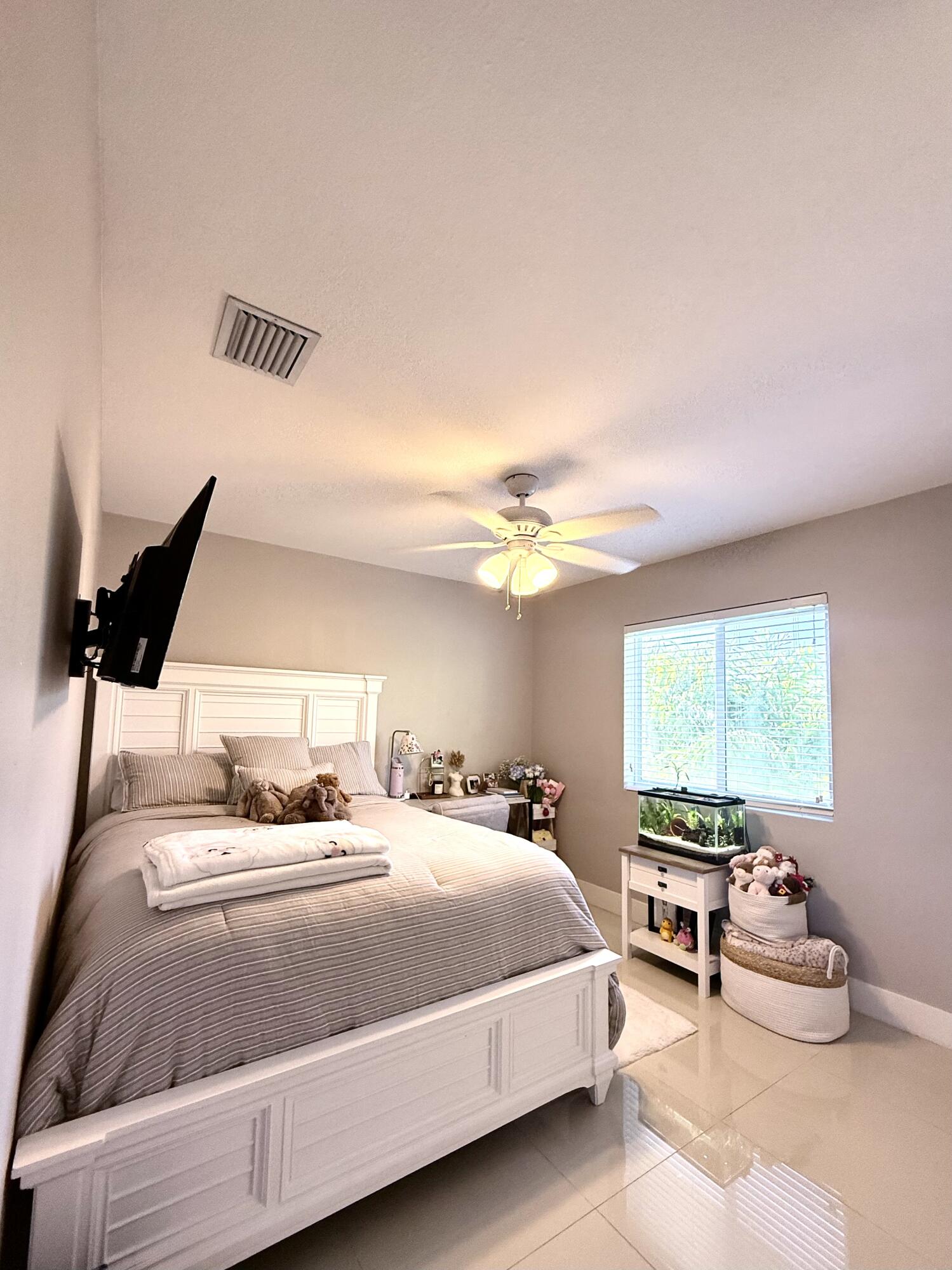 15 Lake View Drive Key Largo, FL 33037 - Photo 39 of 53 a bedroom with a bed and a night stand