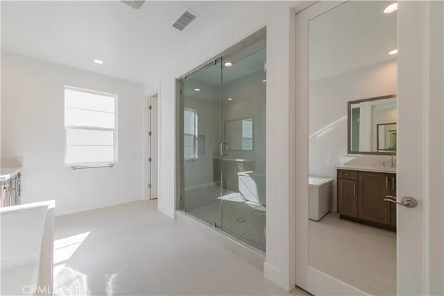 a bathroom with a tub shower and sink