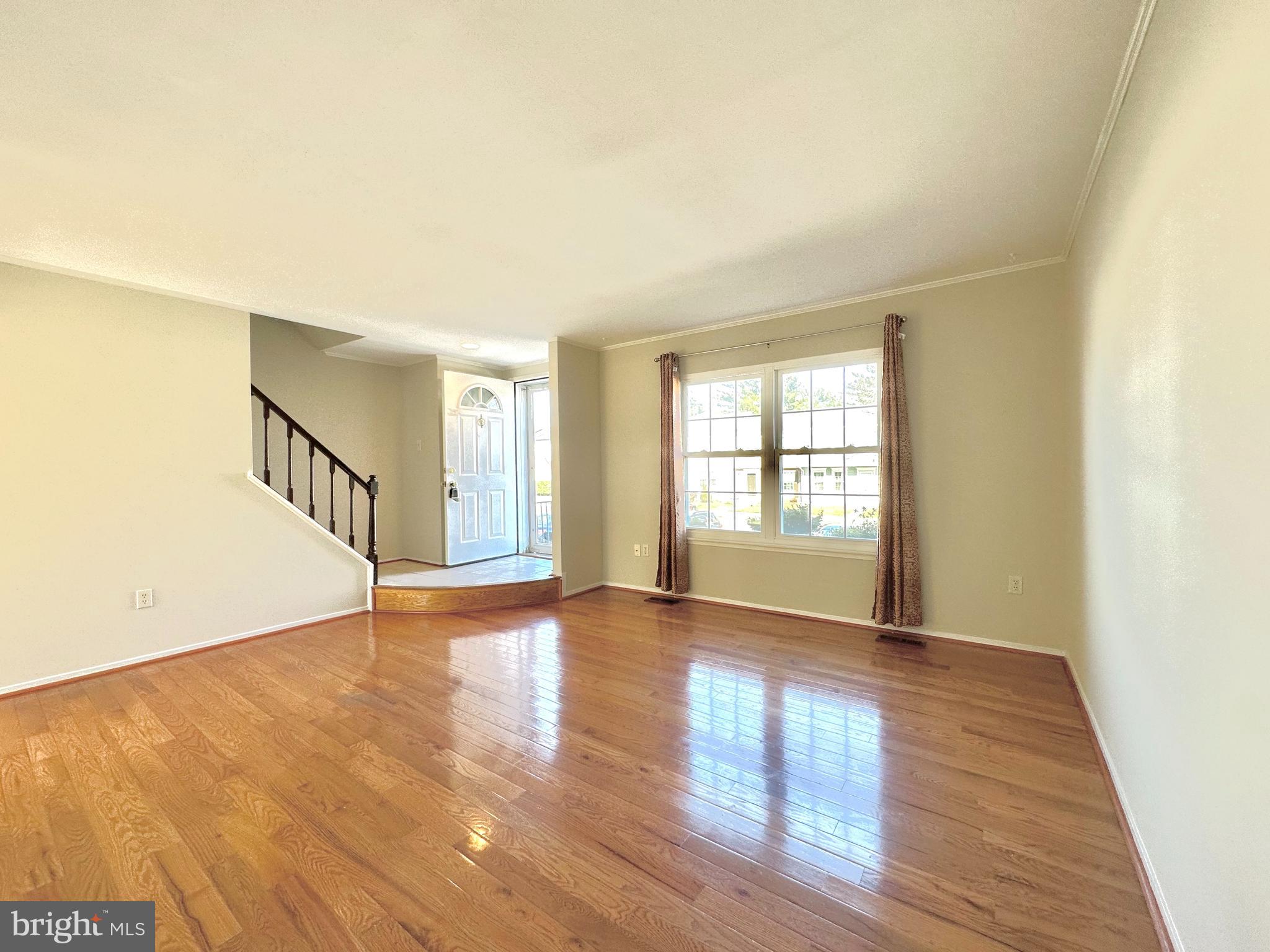 402 Carousel Court Gaithersburg, MD 20877 - Photo 7 of 29 a view of an empty room with wooden floor and a window