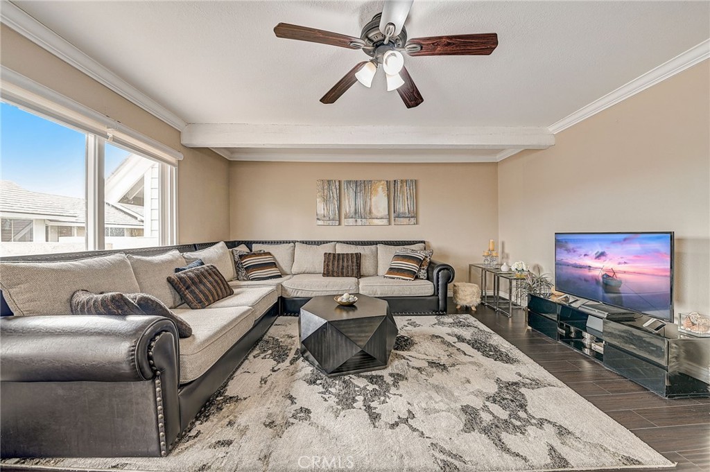 57 Golden Glen Street, Unit 4 Irvine, CA 92604 - Photo 1 of 40 a living room with furniture a large window and a flat screen tv