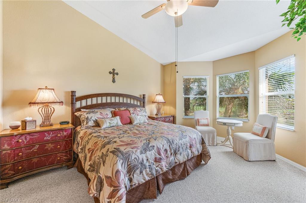 20051 Seagrove Street, Unit 1208 Estero, FL 33928 - Photo 12 of 25 a bedroom with a large bed and a chandelier