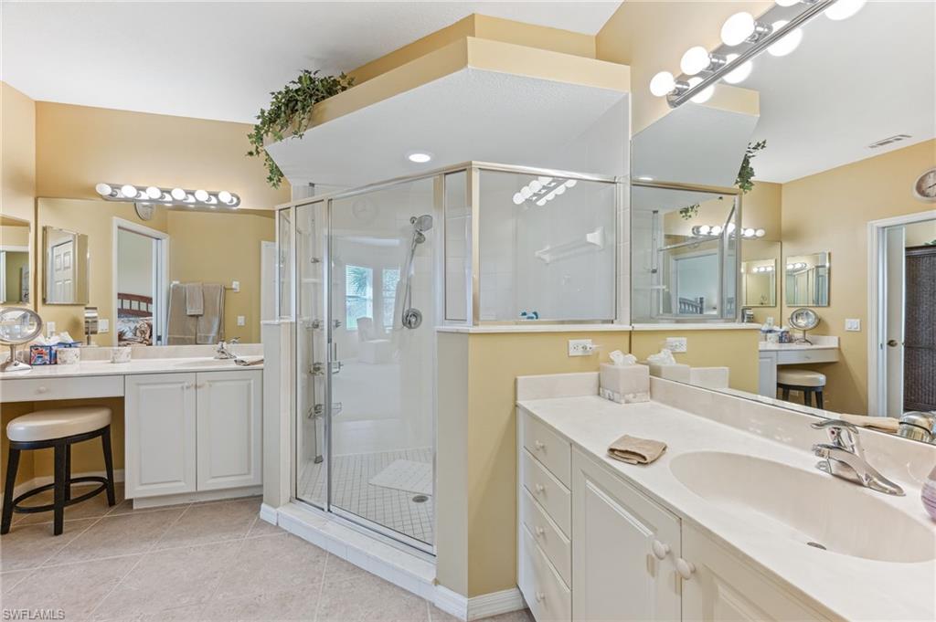 20051 Seagrove Street, Unit 1208 Estero, FL 33928 - Photo 15 of 25 a bathroom with a double vanity sink mirror and shower