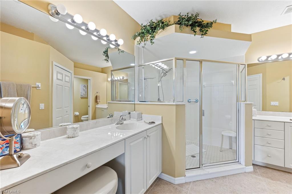 20051 Seagrove Street, Unit 1208 Estero, FL 33928 - Photo 16 of 25 a bathroom with a double vanity sink and a mirror