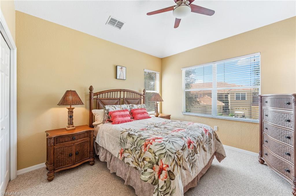 20051 Seagrove Street, Unit 1208 Estero, FL 33928 - Photo 19 of 25 a bedroom with a bed and a ceiling fan