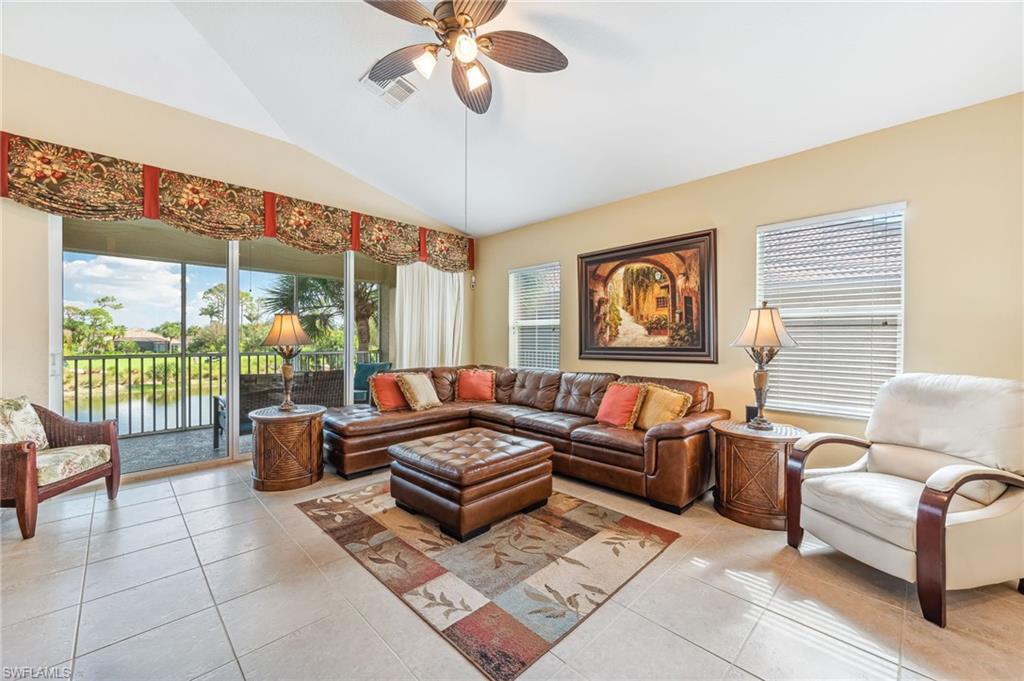 20051 Seagrove Street, Unit 1208 Estero, FL 33928 - Photo 2 of 25 a living room with furniture ceiling fan and a large window