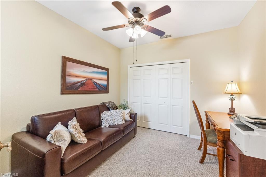 20051 Seagrove Street, Unit 1208 Estero, FL 33928 - Photo 21 of 25 a living room with furniture and a lamp