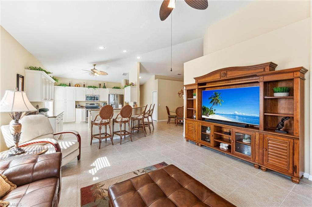 20051 Seagrove Street, Unit 1208 Estero, FL 33928 - Photo 3 of 25 a living room with furniture and a flat screen tv