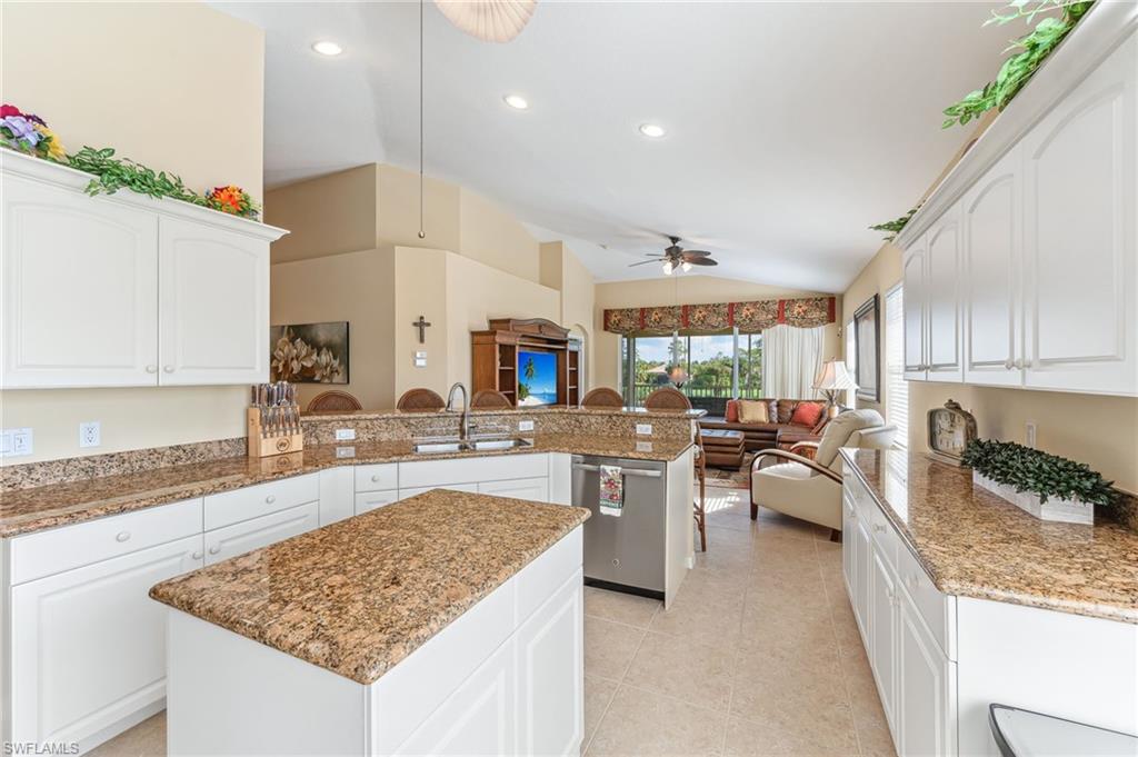 20051 Seagrove Street, Unit 1208 Estero, FL 33928 - Photo 7 of 25 a large kitchen with lots of counter space windows a sink and chairs