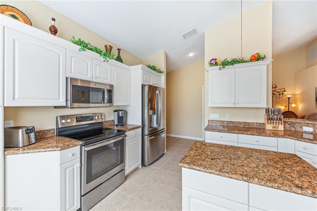 20051 Seagrove Street, Unit 1208 Estero, FL 33928 - Photo 8 of 25 a kitchen with stainless steel appliances granite countertop a sink stove and refrigerator