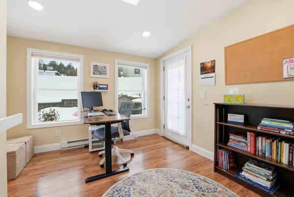 a view of a livingroom with workspace and a window