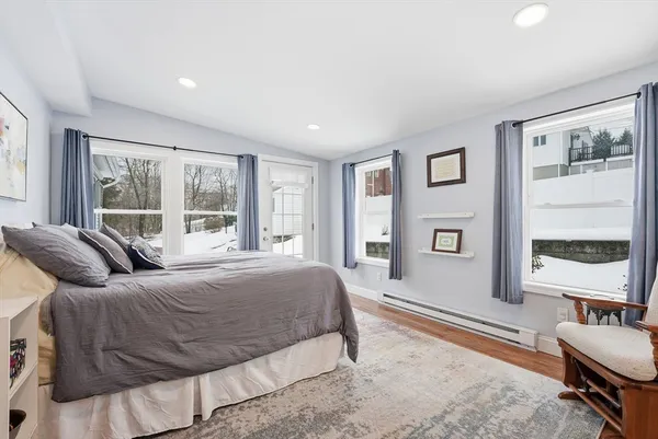 a bedroom with a bed and a large window