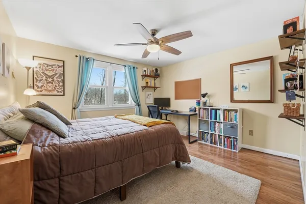 a bedroom with a bed furniture and a bookshelf