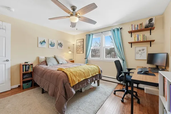 a spacious bedroom with a bed and a desk