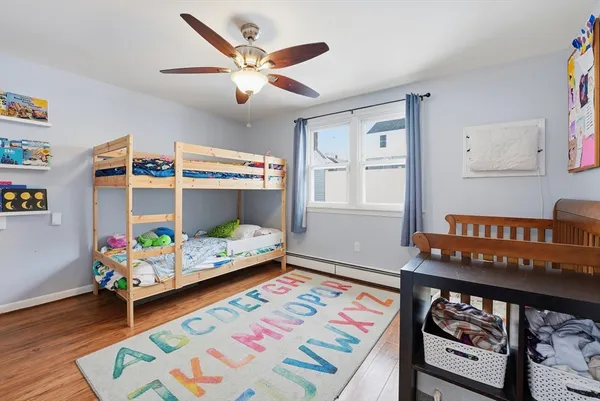 a bedroom with furniture and a wooden floor