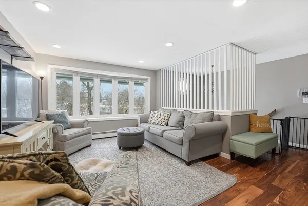 a living room with furniture and a large window