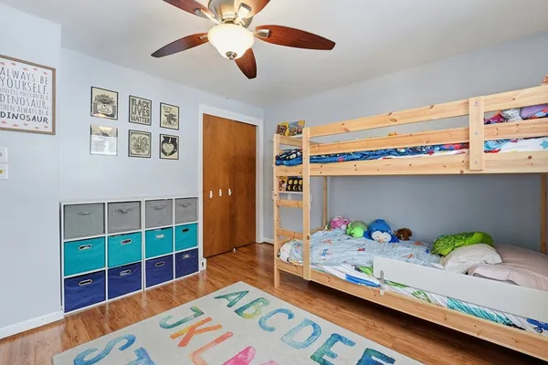 a bedroom with a bed and a bookshelf