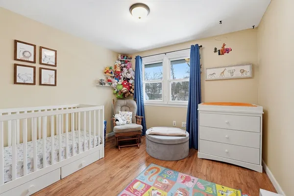 a spacious bedroom with a bed and a window