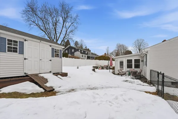 a view of a backyard with a snow on the road