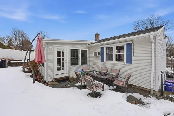 a view of a house with lounge chairs in patio