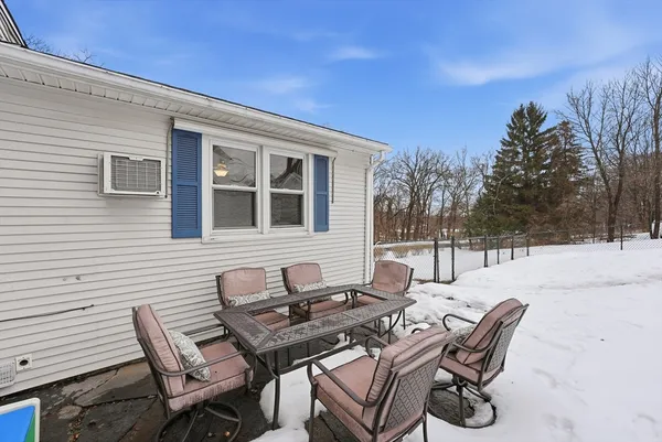 a backyard of a house with table and chairs