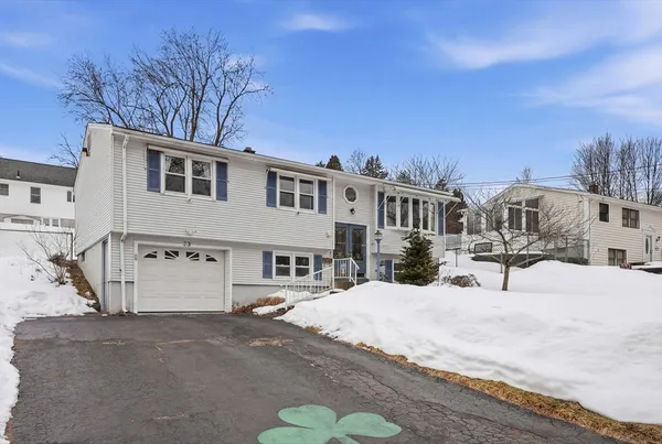 a view of a house with snow on the road