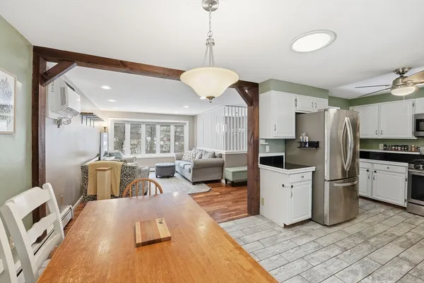 a living room with furniture and kitchen view