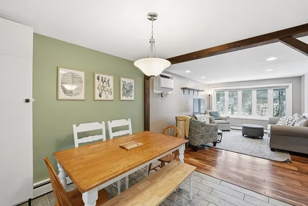 a living room with furniture pool table and a wooden floor