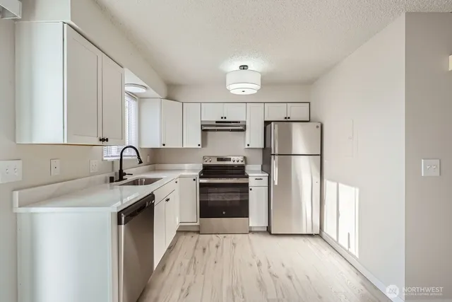 a kitchen with a sink stove and refrigerator