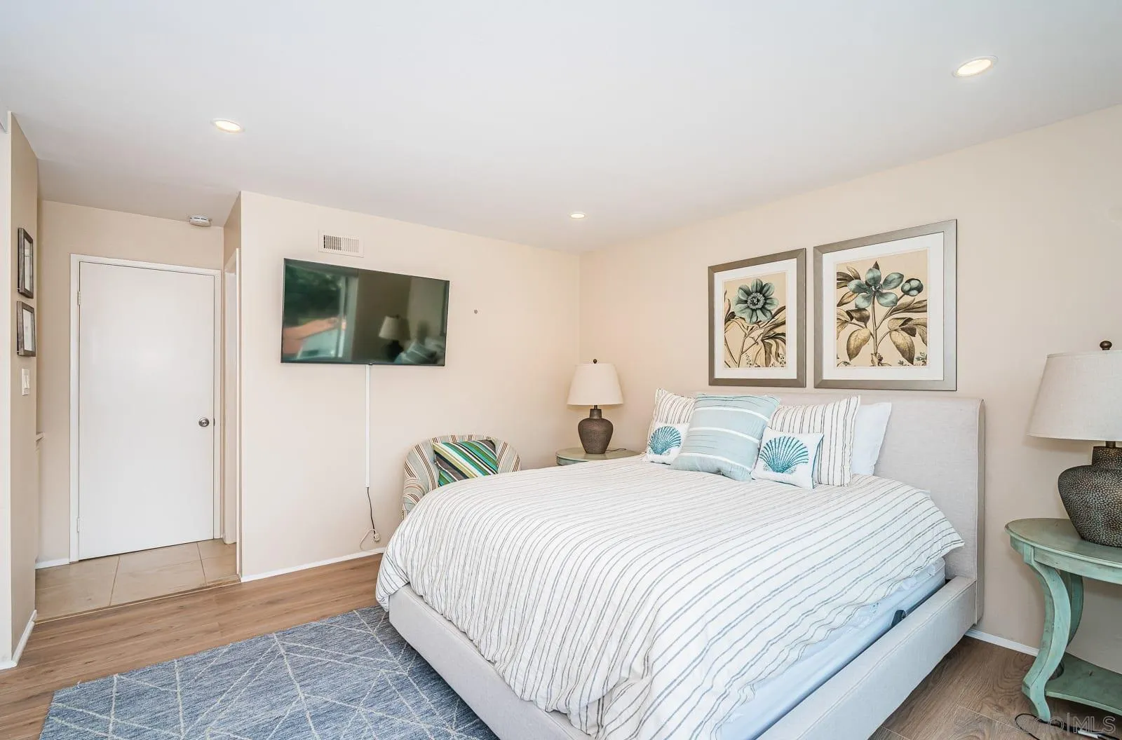 901 Caminito Madrigal, Unit E Carlsbad, CA 92011 - Photo 16 of 28 a bedroom with a bed and a flat screen tv