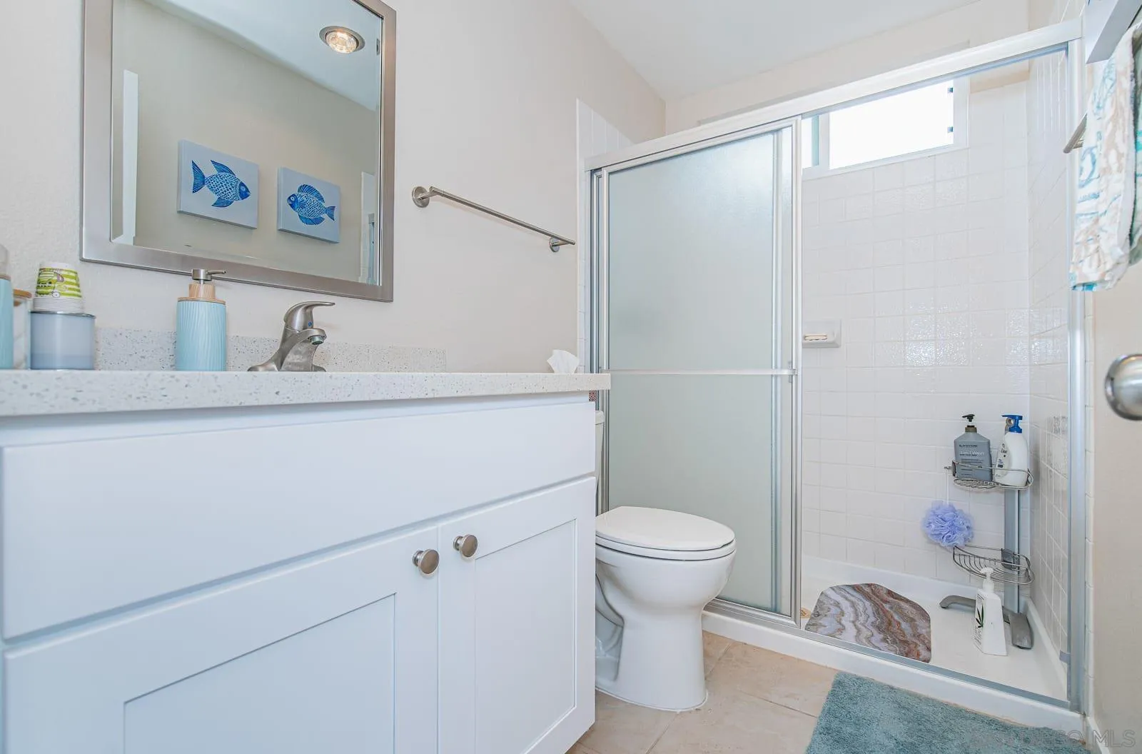 901 Caminito Madrigal, Unit E Carlsbad, CA 92011 - Photo 17 of 28 a bathroom with a sink a toilet and a shower