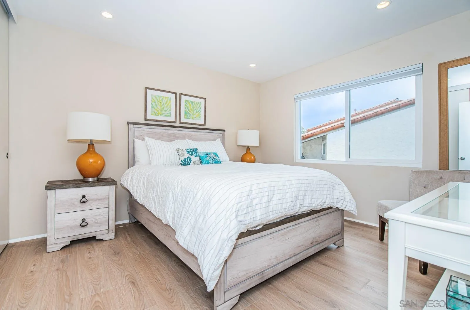 901 Caminito Madrigal, Unit E Carlsbad, CA 92011 - Photo 18 of 28 a bedroom with a bed and a window