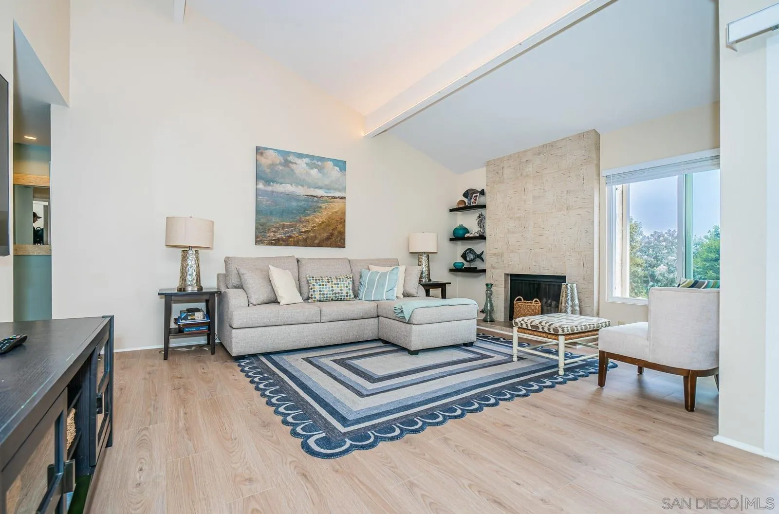 901 Caminito Madrigal, Unit E Carlsbad, CA 92011 - Photo 2 of 28 a living room with furniture and a fireplace