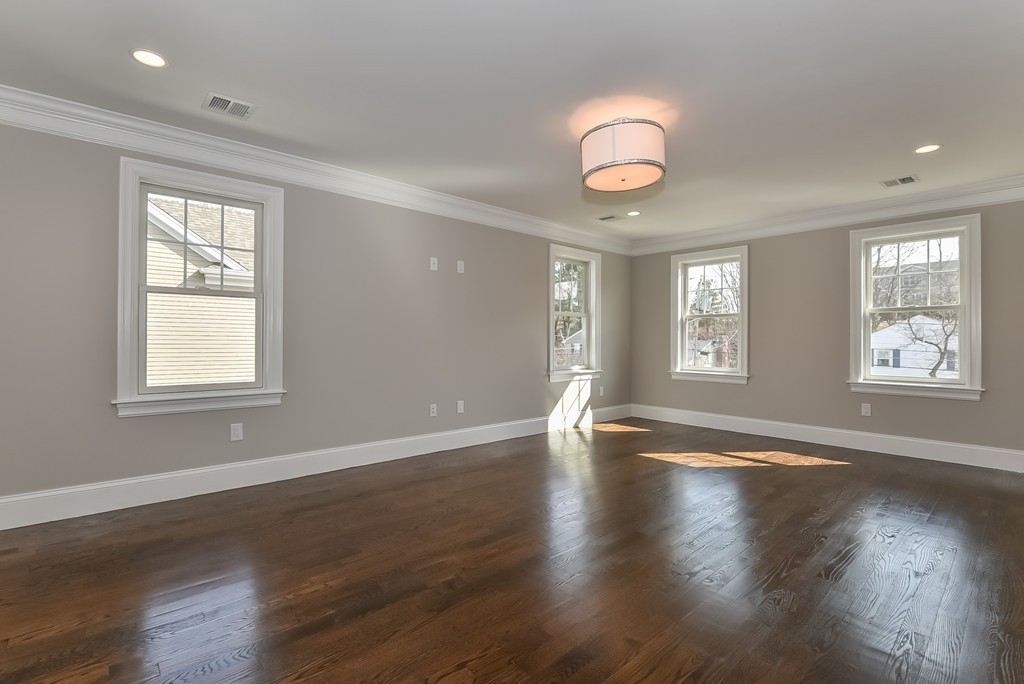 80 Evelyn Road Needham, MA 02494 - Photo 24 of 29 an empty room with wooden floor and windows
