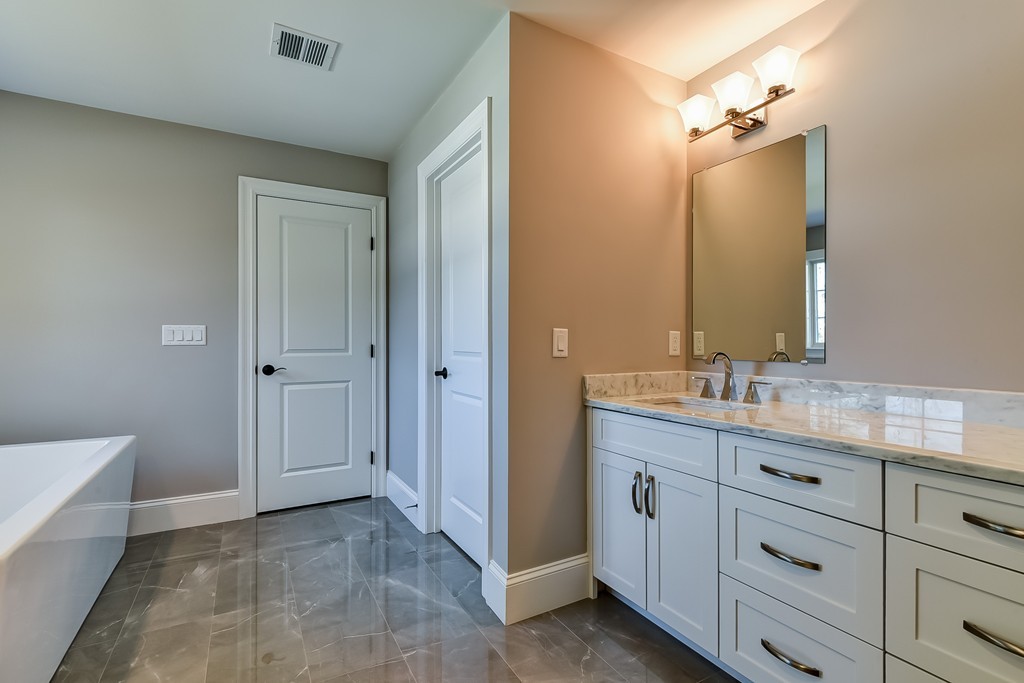 80 Evelyn Road Needham, MA 02494 - Photo 27 of 29 a bathroom with a granite countertop sink mirror and double