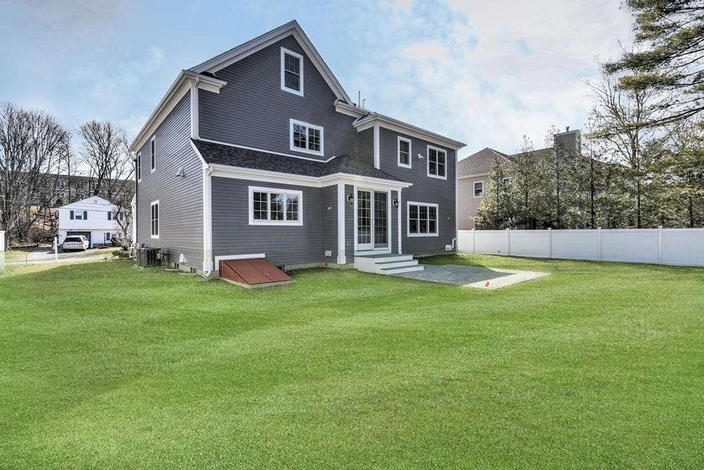 80 Evelyn Road Needham, MA 02494 - Photo 6 of 29 a front view of a house with a garden