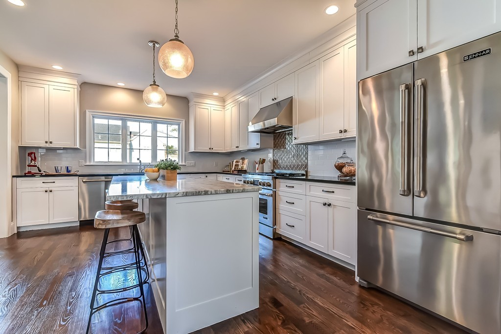 80 Evelyn Road Needham, MA 02494 - Photo 8 of 29 a kitchen with white cabinets and stainless steel appliances