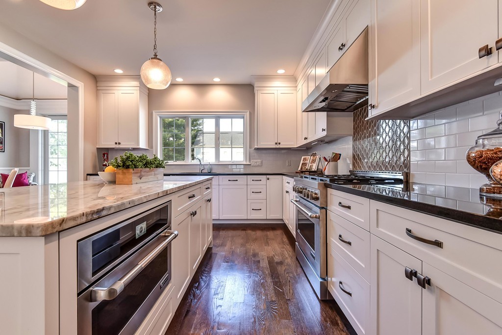 80 Evelyn Road Needham, MA 02494 - Photo 9 of 29 a large kitchen with stainless steel appliances granite countertop a stove a sink and a microwave