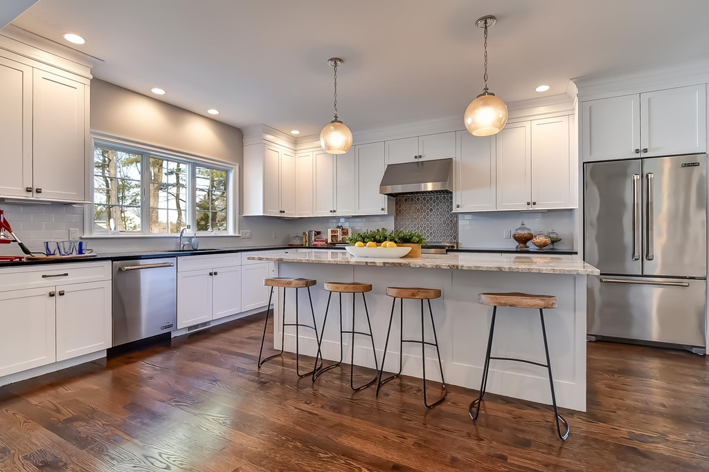 80 Evelyn Road Needham, MA 02494 - Photo 10 of 29 a kitchen with stainless steel appliances granite countertop a refrigerator a sink dishwasher a stove and white cabinets with wooden floor