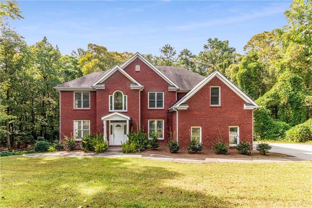 3075 Shaw Road Marietta, GA 30066 - Photo 1 of 1 a front view of a house with a yard