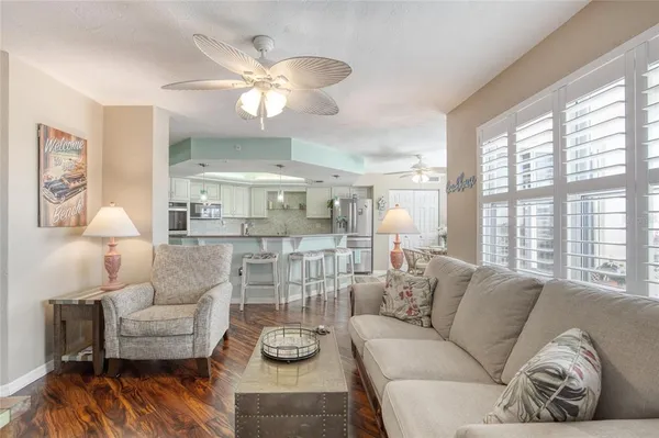 a dining room with furniture a chandelier and wooden floor