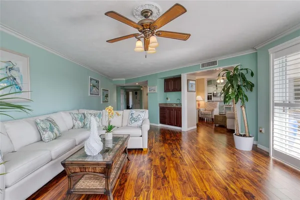 a spacious bedroom with a bed and a flat tv screen on dresser
