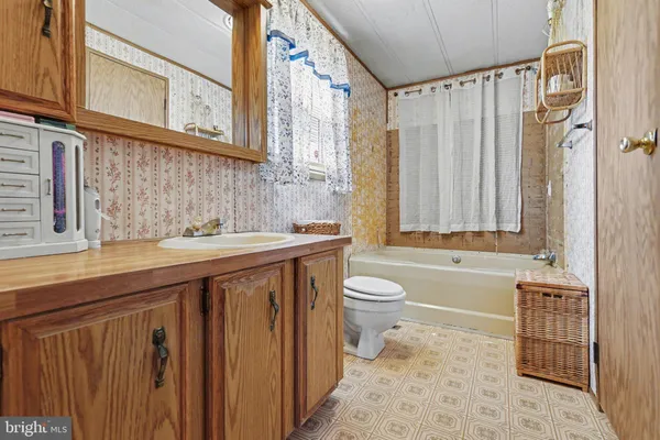 a bathroom with a sink a toilet and bathtub