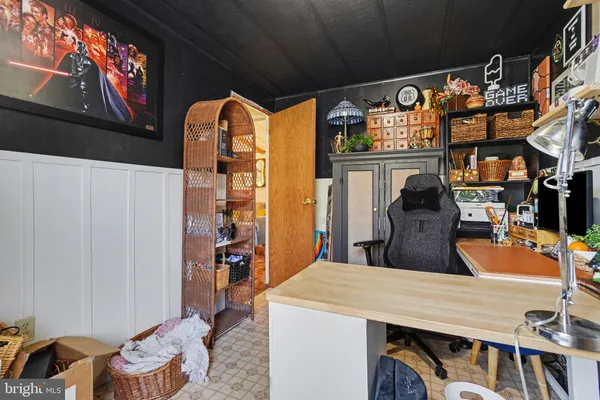 a dining table chairs in a room and a flat screen tv