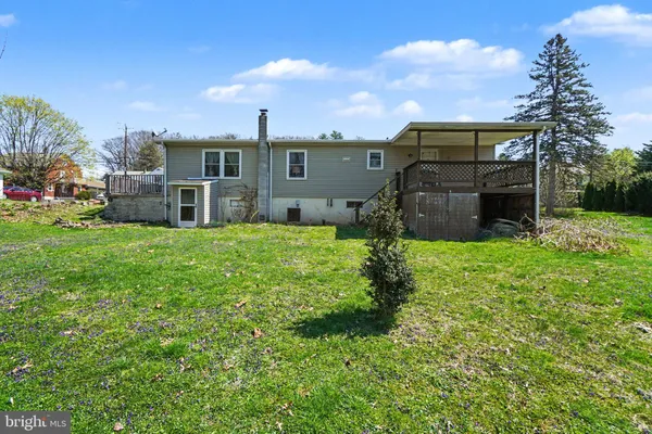 a view of a house with a yard and sitting area