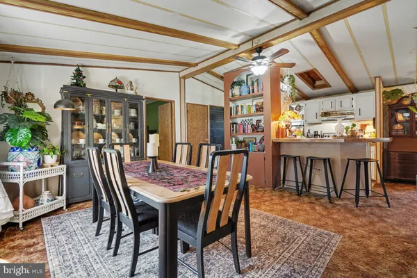 a dining room with a wooden table and chairs