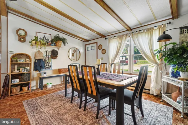 a dining room with furniture and window
