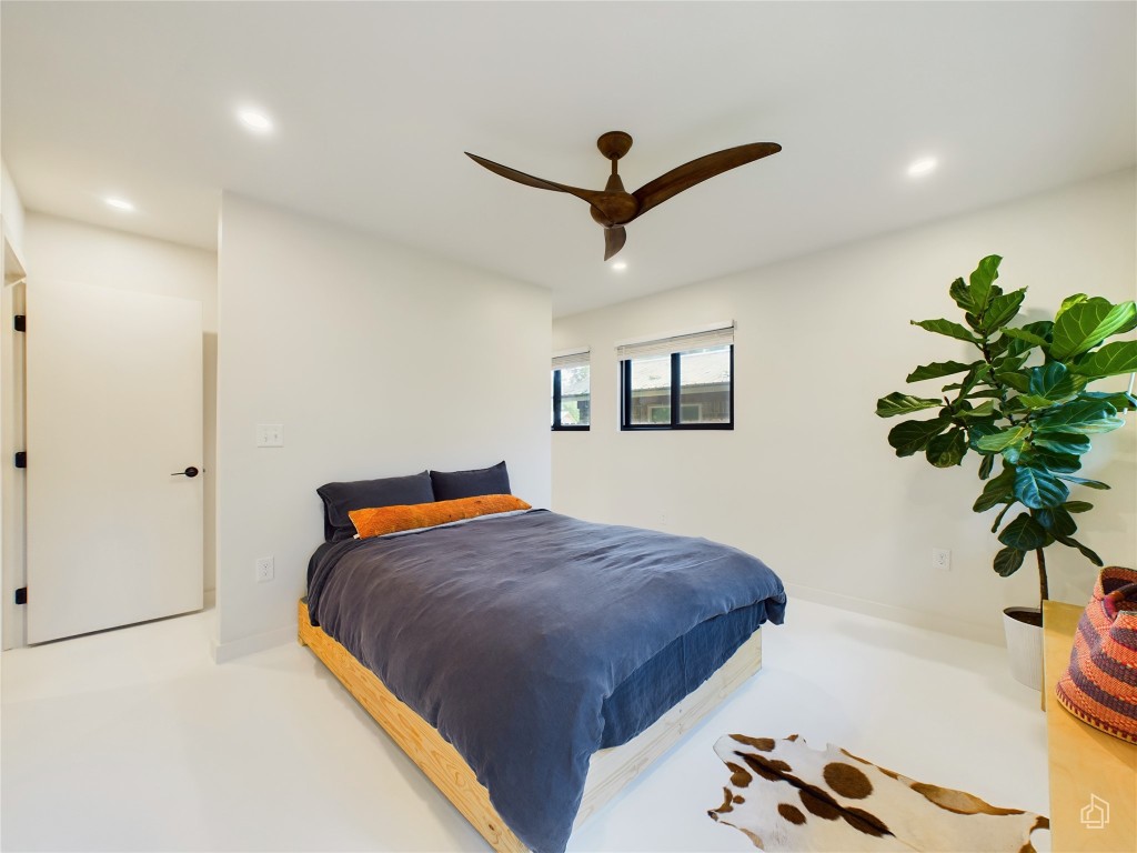 6007 Leisure Run Road Austin, TX 78745 - Photo 12 of 26 a bedroom with a bed and a potted plant