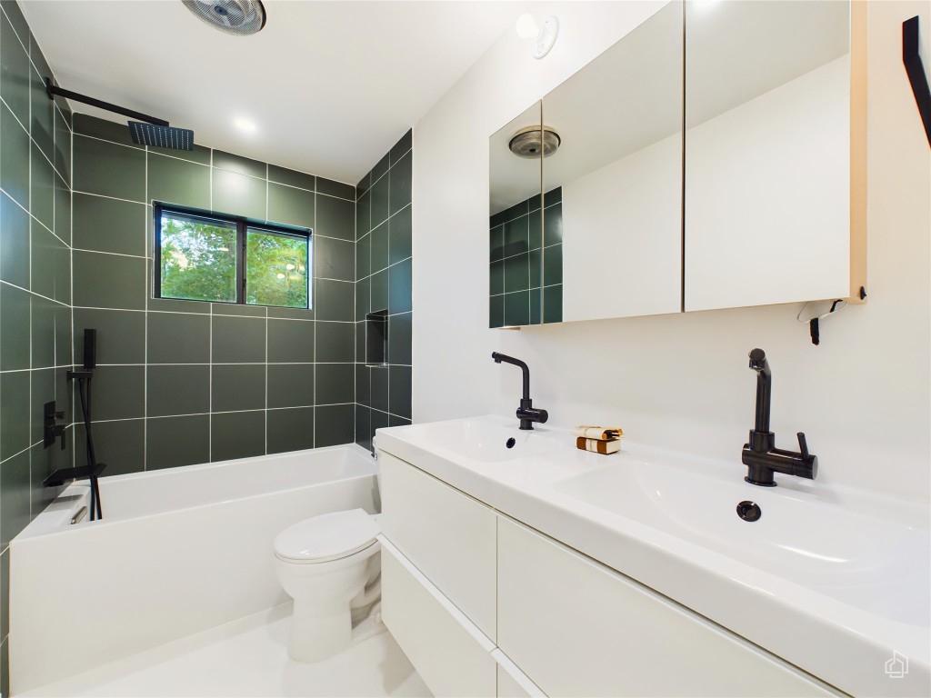 6007 Leisure Run Road Austin, TX 78745 - Photo 20 of 26 a bathroom with a sink a toilet and shower
